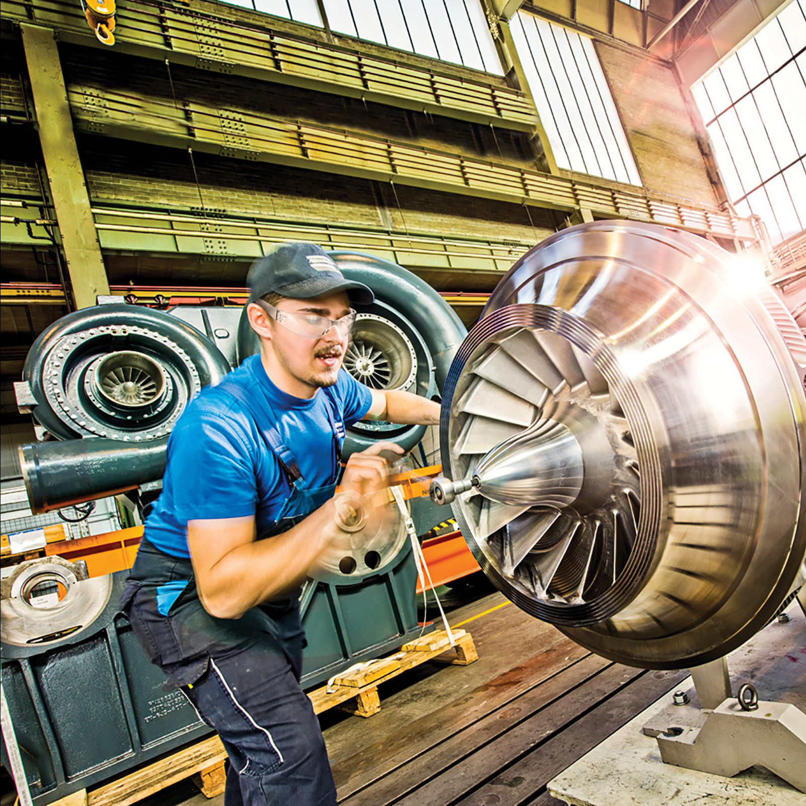 BRE technician performing maintenance on an industrial air compressor.